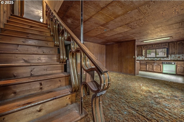 stairs featuring wood ceiling and wooden walls