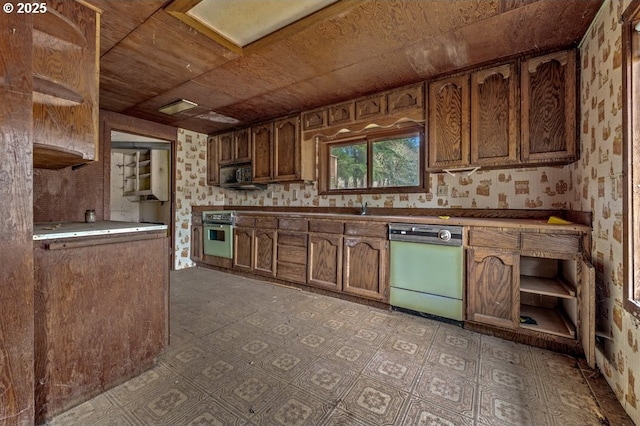 kitchen featuring oven, dishwasher, stainless steel microwave, and wallpapered walls