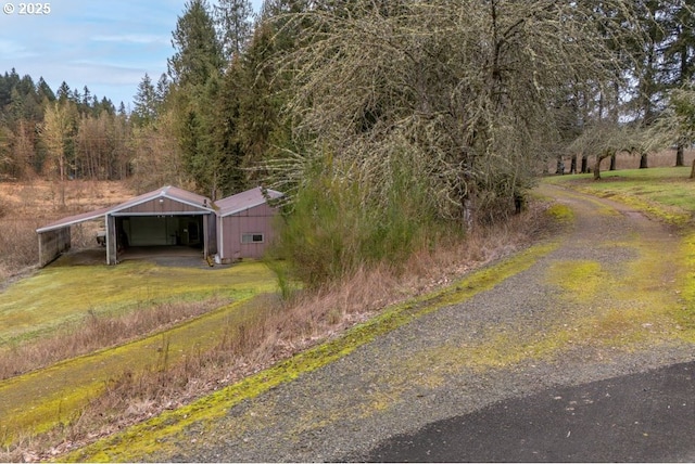 view of street with an outbuilding and driveway