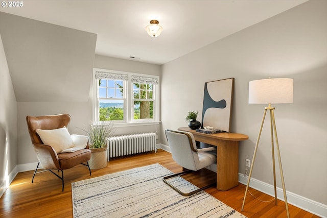 3146 NE Alameda Ter, Portland, OR 97212 - office area featuring radiator heating unit and wood finished floors