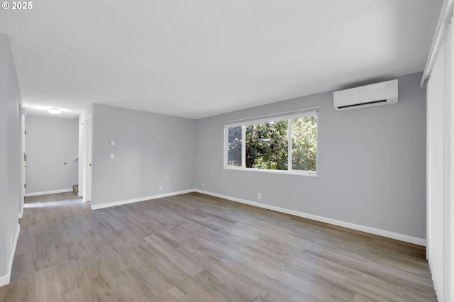 1500 Norkenzie Rd, Eugene, OR 97401 - spare room with a wall mounted air conditioner and wood finished floors