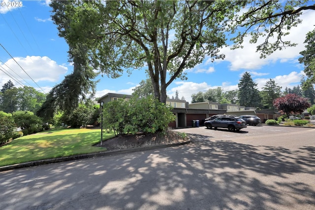 1500 Norkenzie Rd, Eugene, OR 97401 - view of property hidden behind natural elements featuring a front yard and stucco siding