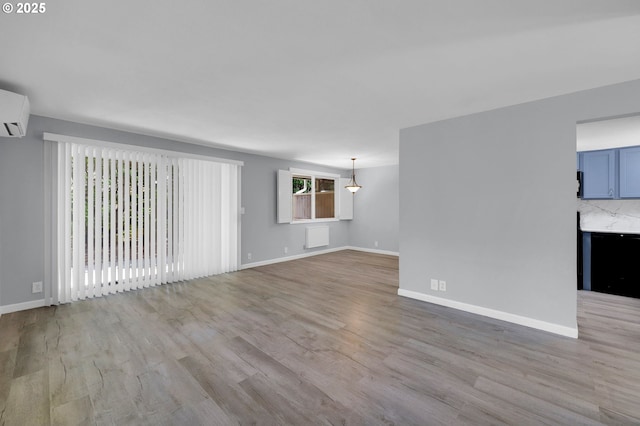 1500 Norkenzie Rd, Eugene, OR 97401 - unfurnished living room with light wood finished floors and an AC wall unit