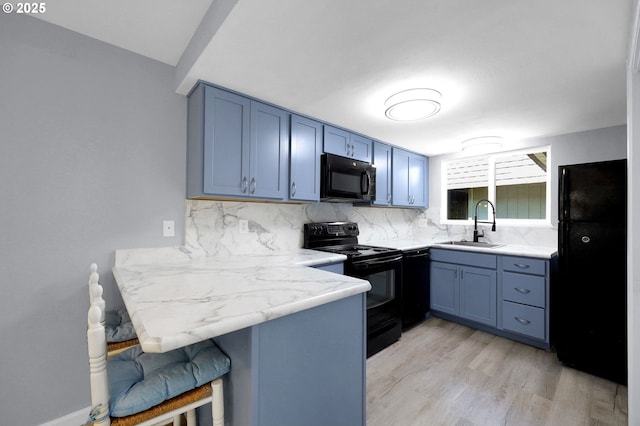 1500 Norkenzie Rd, Eugene, OR 97401 - kitchen featuring black appliances, tasteful backsplash, a breakfast bar, a peninsula, and light wood-type flooring