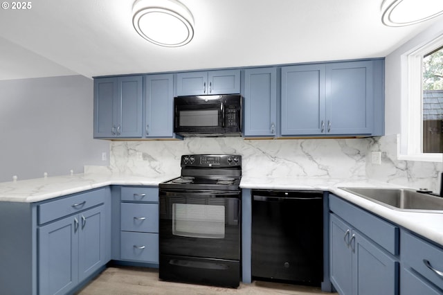 1500 Norkenzie Rd, Eugene, OR 97401 - kitchen with black appliances, blue cabinetry, decorative backsplash, and a peninsula
