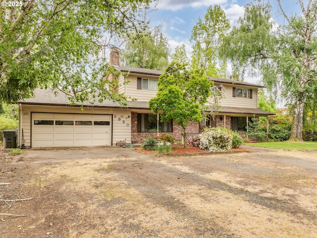 view of front of house with driveway, a garage, and a chimney