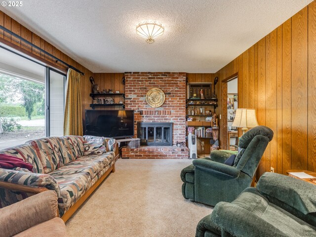 carpeted living area featuring wooden walls, a textured ceiling, and a brick fireplace