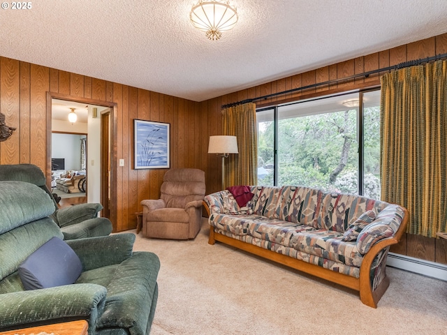 living room featuring carpet flooring, wood walls, and a textured ceiling