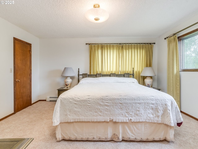 carpeted bedroom with baseboards, baseboard heating, and a textured ceiling