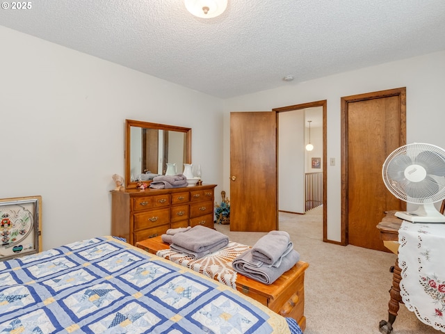 bedroom with light carpet and a textured ceiling