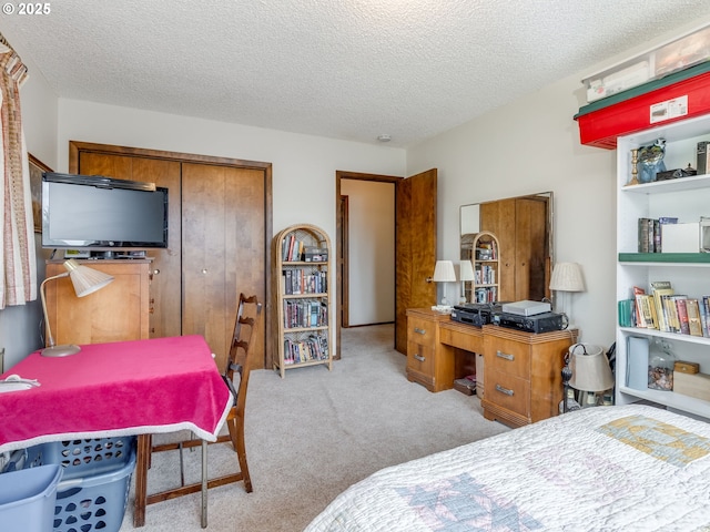 bedroom with carpet, a closet, and a textured ceiling