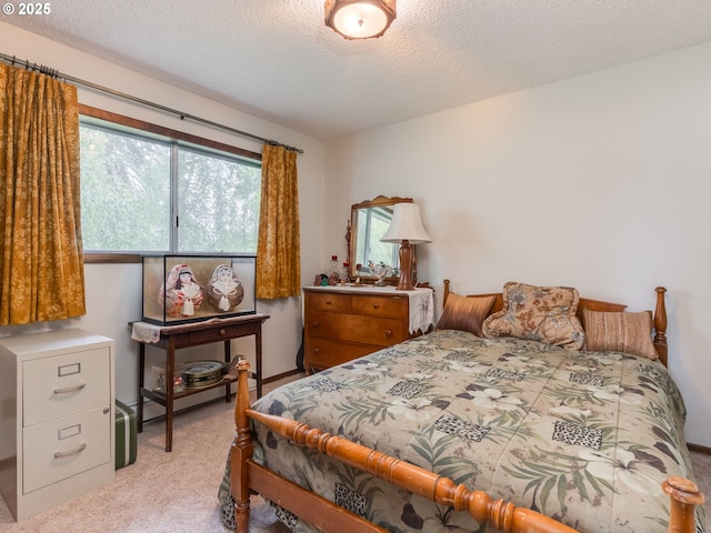 bedroom with light carpet, multiple windows, and a textured ceiling