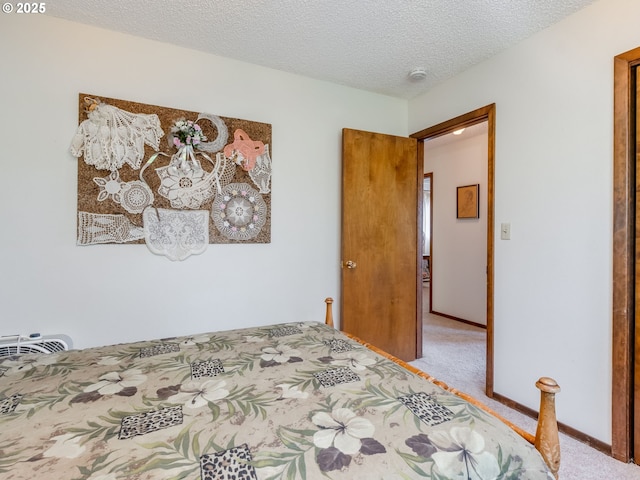 carpeted bedroom with a textured ceiling