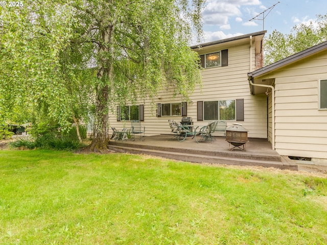 rear view of house featuring a yard, a patio, and a deck