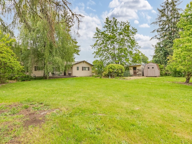 view of green lawn featuring a shed and an outdoor structure