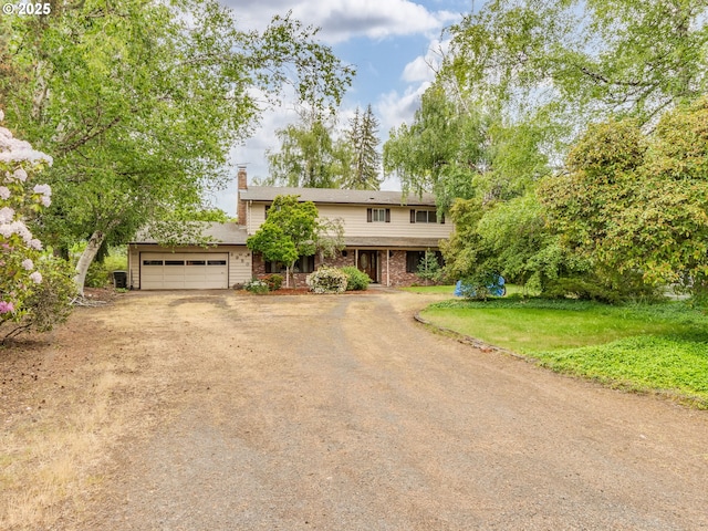 traditional-style home featuring dirt driveway, a chimney, a garage, and brick siding