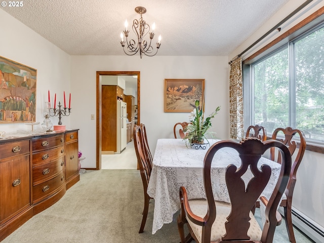 dining room featuring a textured ceiling, a chandelier, light colored carpet, and a baseboard heating unit