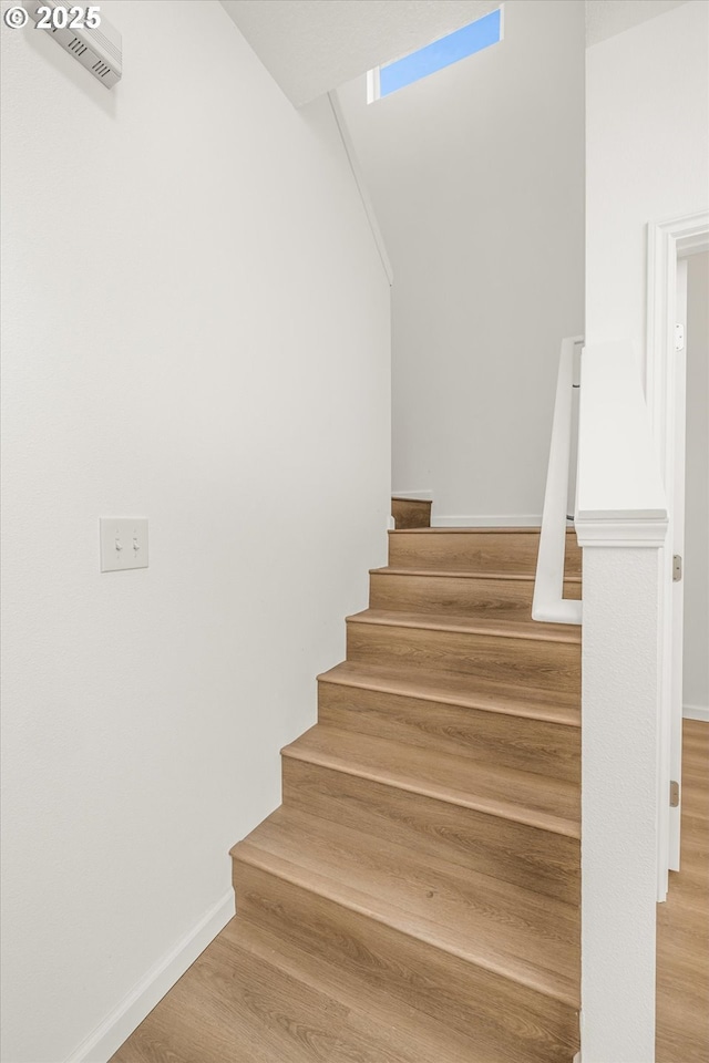 stairway with hardwood / wood-style flooring