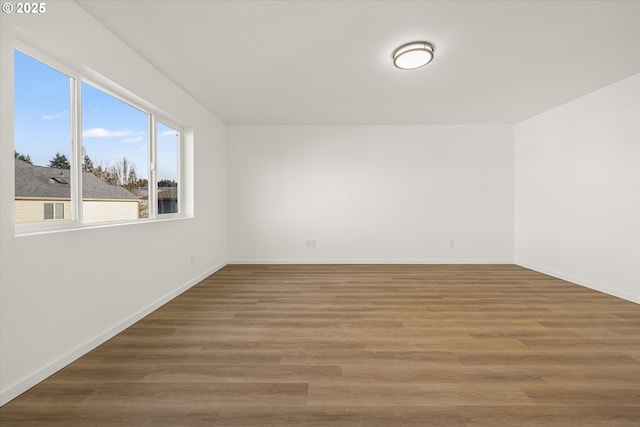 spare room with dark hardwood / wood-style floors