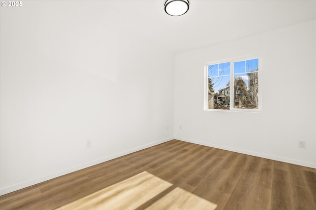 spare room with hardwood / wood-style flooring