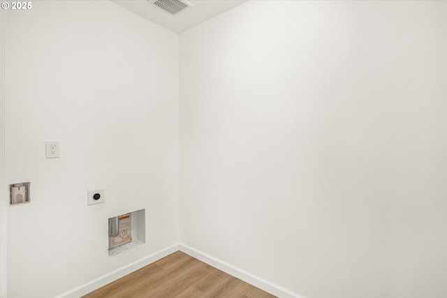 laundry room featuring wood-type flooring and hookup for an electric dryer