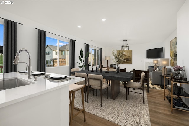 dining area featuring hardwood / wood-style floors and sink