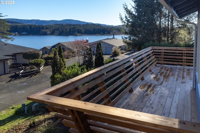 deck with a water and mountain view