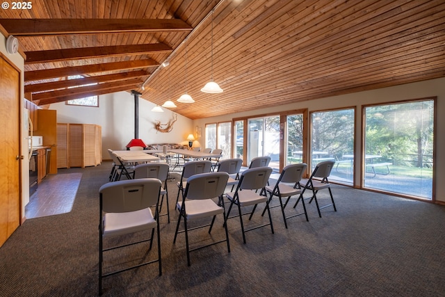 carpeted dining room featuring wood ceiling, plenty of natural light, beam ceiling, and high vaulted ceiling