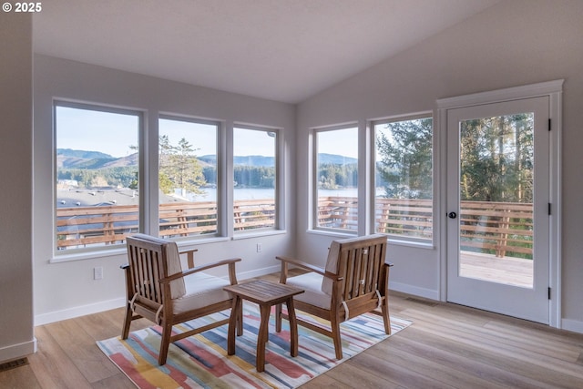 sunroom / solarium featuring a mountain view and vaulted ceiling