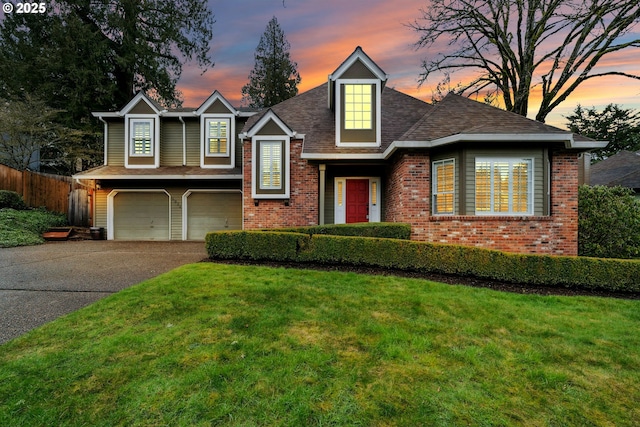 view of front facade with a garage, concrete driveway, brick siding, and a front lawn