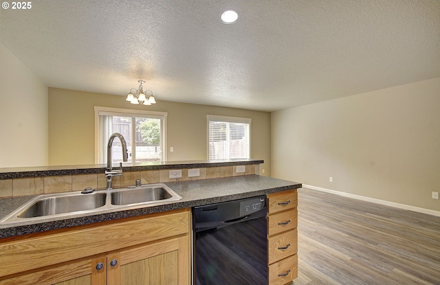 9513 NE 73rd St, Vancouver, WA 98662 - kitchen featuring black dishwasher, a sink, dark countertops, a chandelier, and wood finished floors