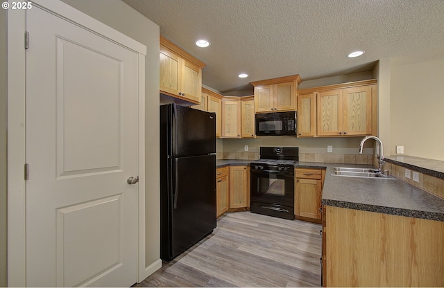 9513 NE 73rd St, Vancouver, WA 98662 - kitchen with black appliances, a sink, dark countertops, a textured ceiling, and light wood-style floors