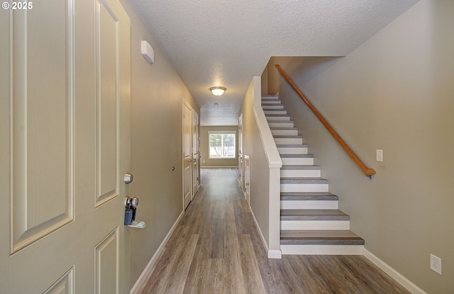 9513 NE 73rd St, Vancouver, WA 98662 - staircase with a textured ceiling, wood finished floors, and baseboards