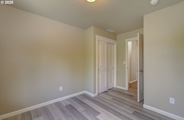 9513 NE 73rd St, Vancouver, WA 98662 - unfurnished bedroom featuring wood finished floors, baseboards, a closet, and a textured ceiling