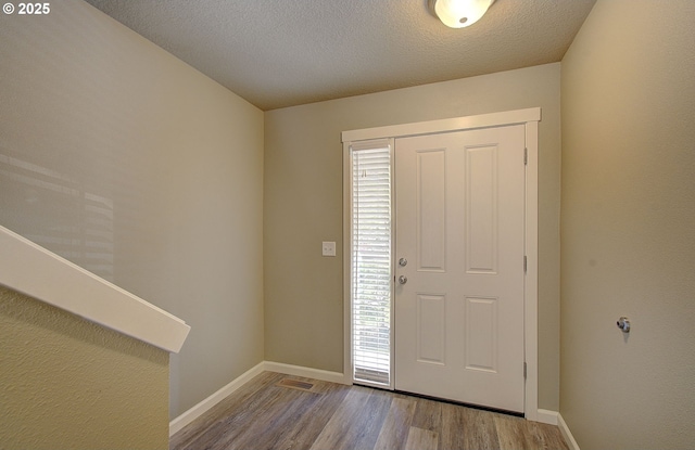 9513 NE 73rd St, Vancouver, WA 98662 - entryway featuring wood finished floors, baseboards, and a textured ceiling