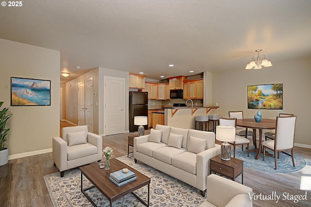 9513 NE 73rd St, Vancouver, WA 98662 - living room with a chandelier, baseboards, light wood finished floors, and recessed lighting