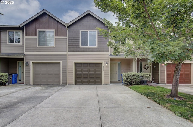9513 NE 73rd St, Vancouver, WA 98662 - view of property featuring concrete driveway, a garage, and board and batten siding