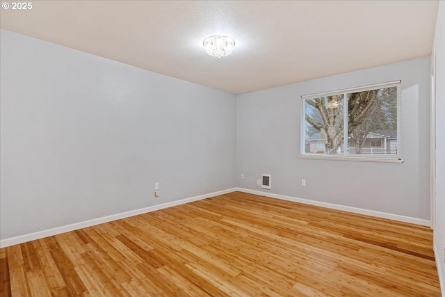 empty room with hardwood / wood-style floors