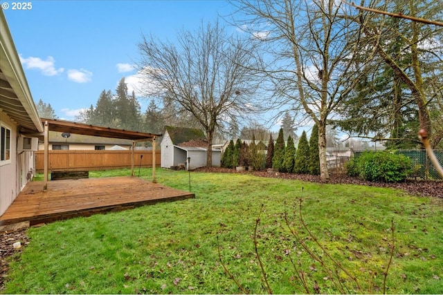 view of yard with a deck and a storage unit