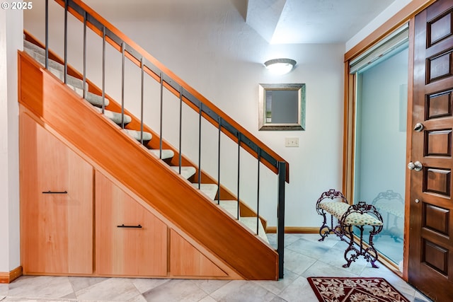 stairway featuring baseboards
