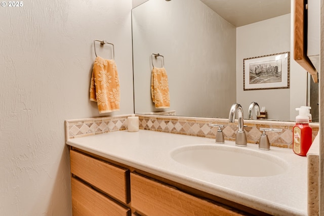 bathroom featuring vanity and tasteful backsplash