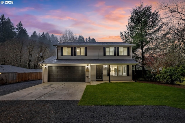 front facade with a garage and a lawn