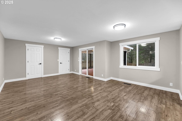 unfurnished room featuring dark hardwood / wood-style floors