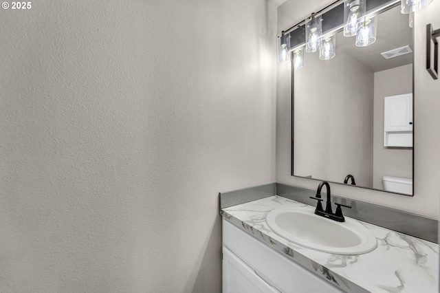 bathroom with toilet and vanity