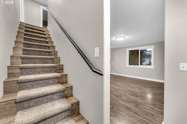 staircase featuring wood-type flooring