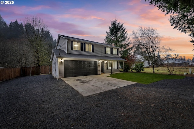 view of property with a lawn and a garage