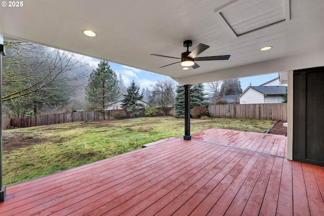 deck with ceiling fan and a yard