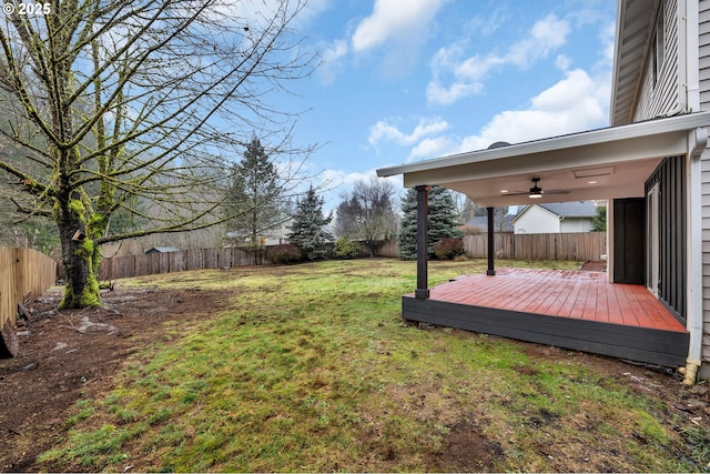 view of yard featuring a wooden deck and ceiling fan