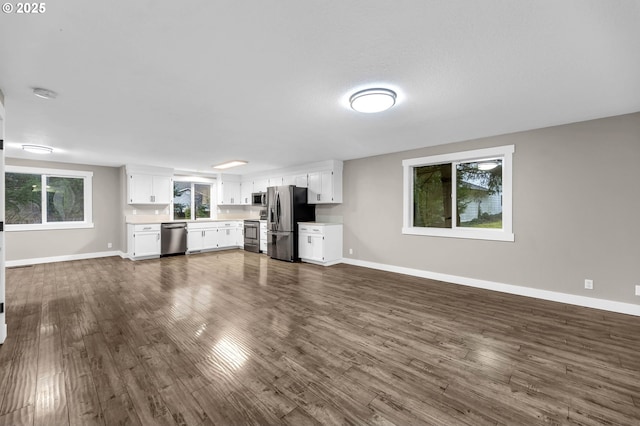 unfurnished living room with dark wood-type flooring