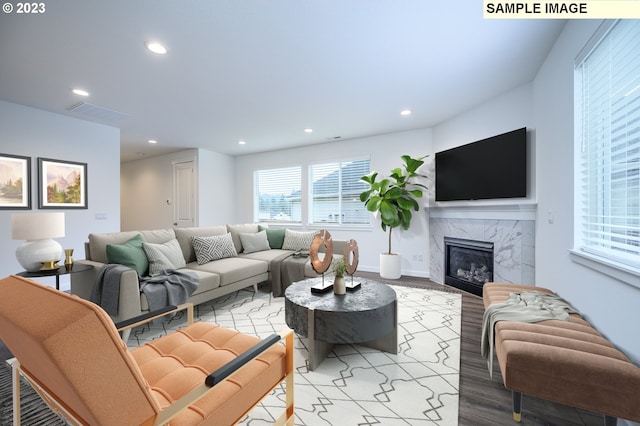 living room featuring recessed lighting, visible vents, light wood-style flooring, and a fireplace